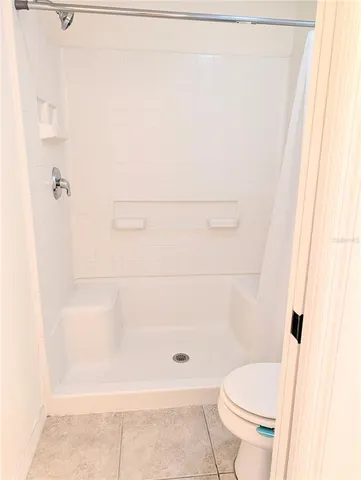 a bathroom with a shower and toilet