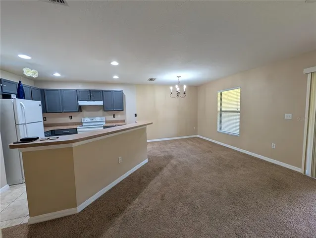 a kitchen with stainless steel appliances granite countertop a refrigerator sink and cabinets