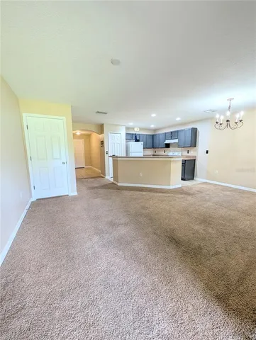 a view of a room with a kitchen