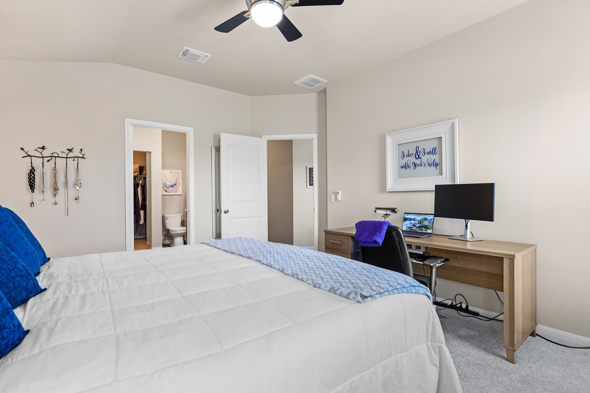 404 Cassandra Drive Hutto, TX 78634 - Photo 16 of 40 Bedroom with carpet, a spacious closet, a ceiling fan, lofted ceiling, and an office area