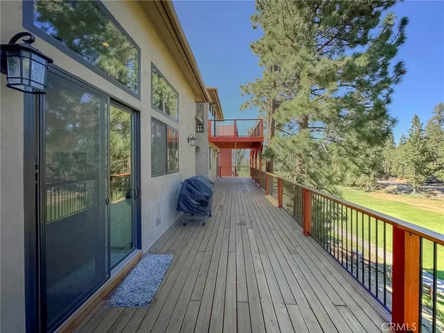 a view of a balcony with wooden floor