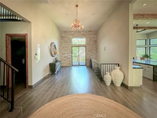 a view of a room with wooden floor and windows