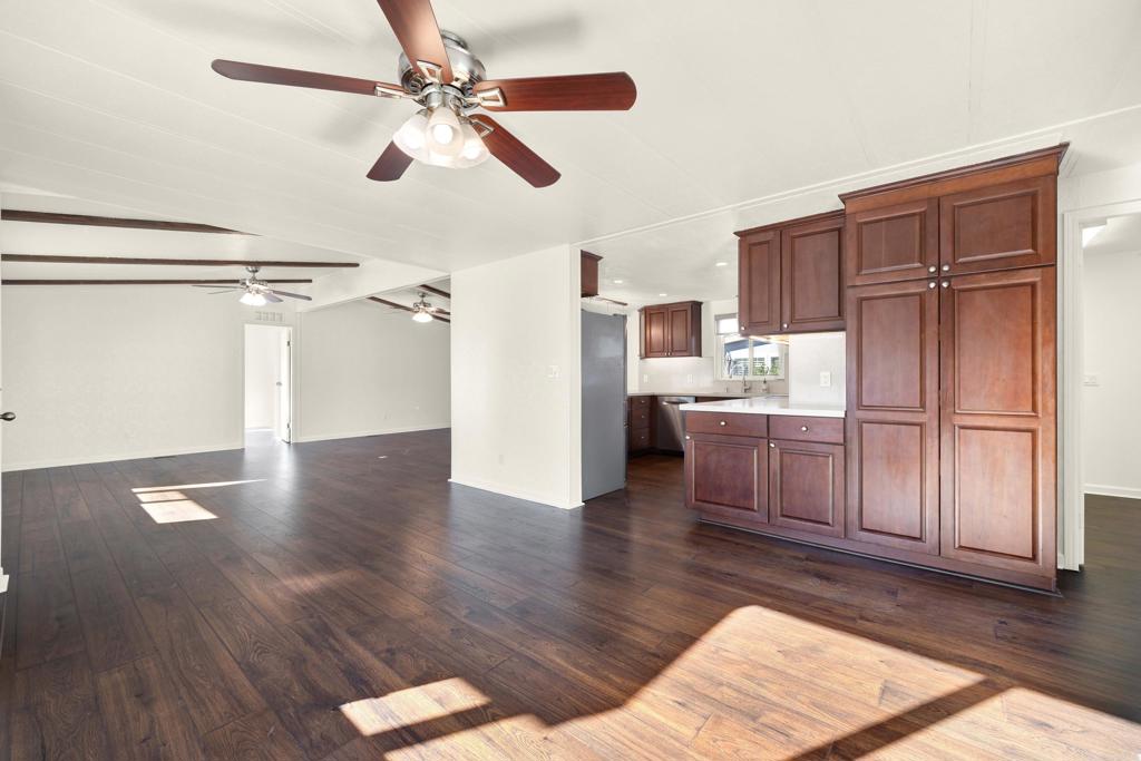 9255 North Magnolia Avenue, Unit SPC 158 Santee, CA 92071 - Photo 11 of 49 a kitchen with stainless steel appliances a refrigerator and wooden floor