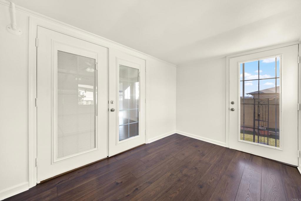 9255 North Magnolia Avenue, Unit SPC 158 Santee, CA 92071 - Photo 18 of 49 an empty room with wooden floor and windows