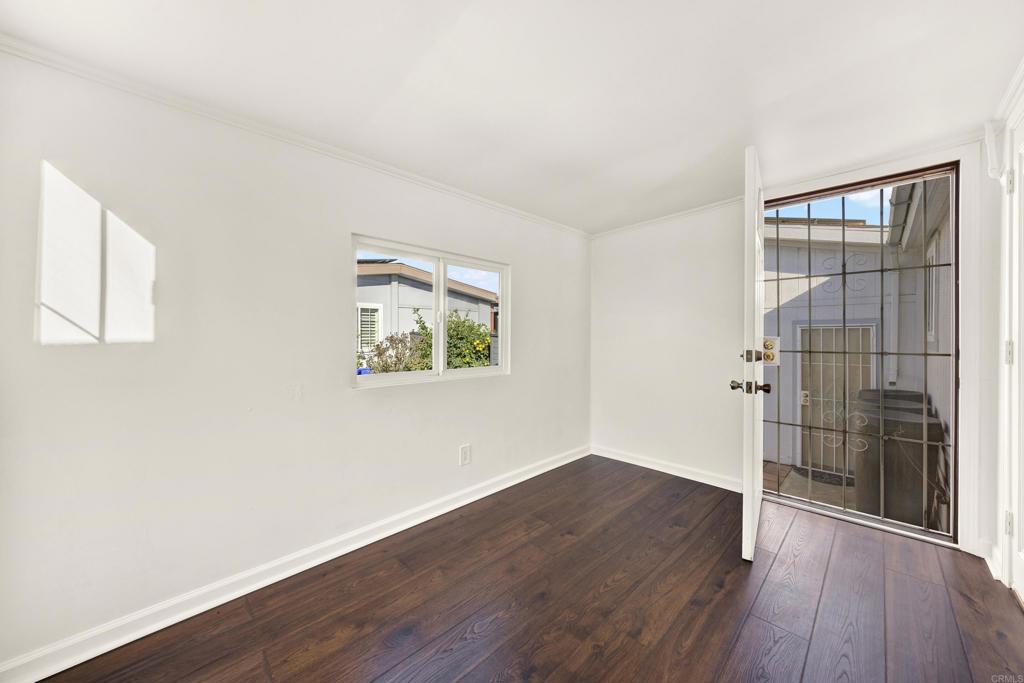 9255 North Magnolia Avenue, Unit SPC 158 Santee, CA 92071 - Photo 19 of 49 an empty room with wooden floor and a window
