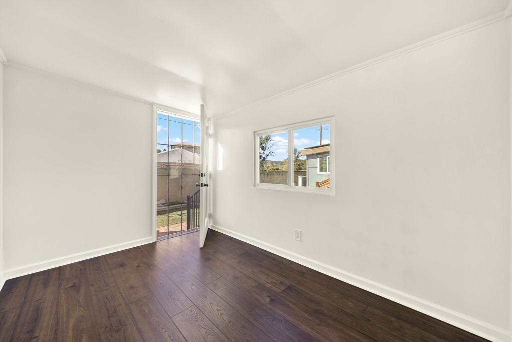 9255 North Magnolia Avenue, Unit SPC 158 Santee, CA 92071 - Photo 20 of 49 an empty room with wooden floor and a window