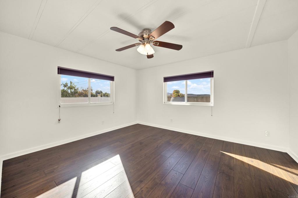 9255 North Magnolia Avenue, Unit SPC 158 Santee, CA 92071 - Photo 21 of 49 a view of an empty room with wooden floor and a window