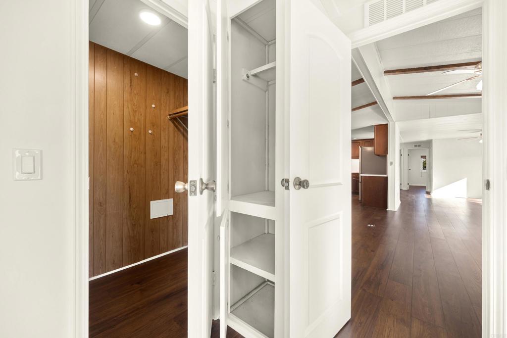 9255 North Magnolia Avenue, Unit SPC 158 Santee, CA 92071 - Photo 23 of 49 a view of a hallway with wooden floor staircase and a bathroom