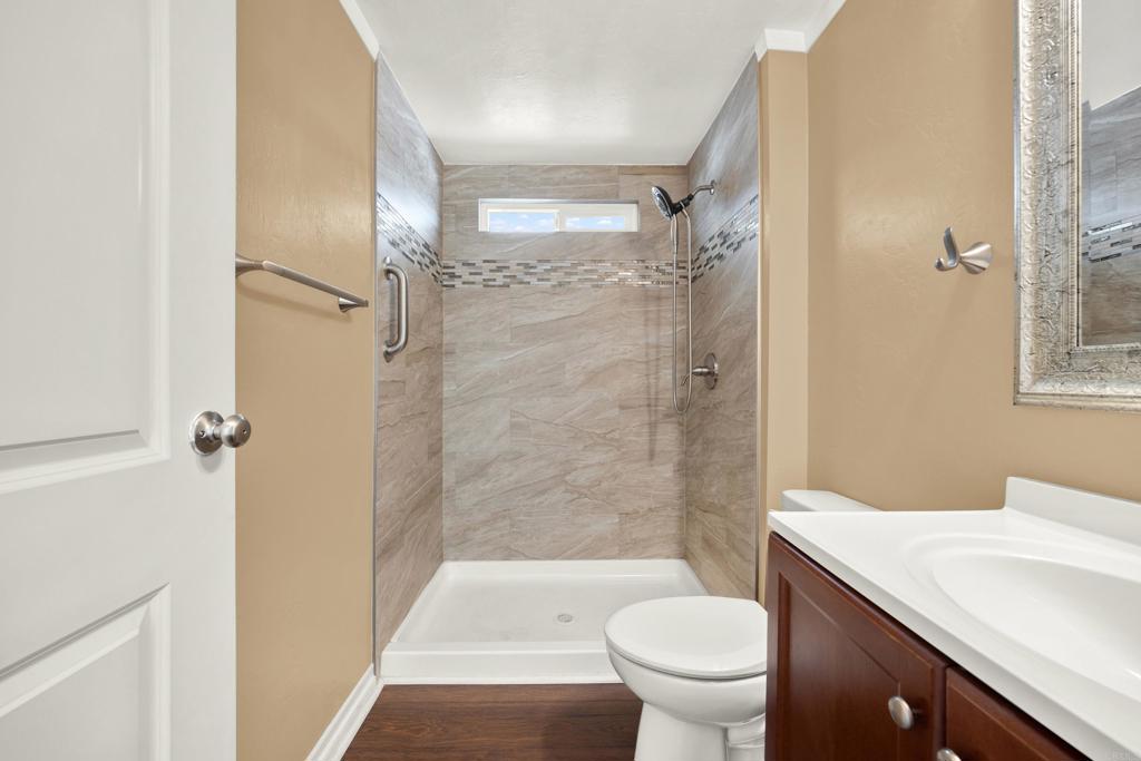 9255 North Magnolia Avenue, Unit SPC 158 Santee, CA 92071 - Photo 30 of 49 a bathroom with a granite countertop toilet a sink and a shower