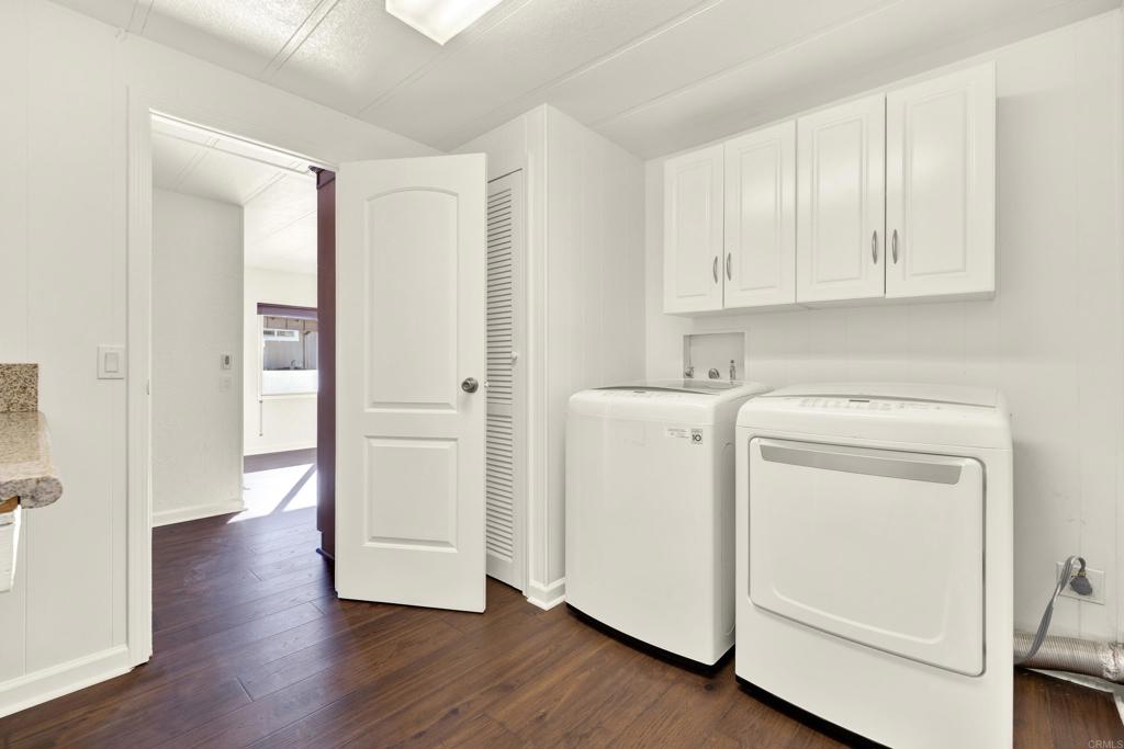 9255 North Magnolia Avenue, Unit SPC 158 Santee, CA 92071 - Photo 32 of 49 a view of washer and dryer with wooden floor