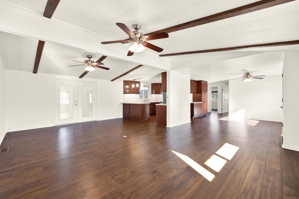 9255 North Magnolia Avenue, Unit SPC 158 Santee, CA 92071 - Photo 4 of 49 an empty room with wooden floor and windows