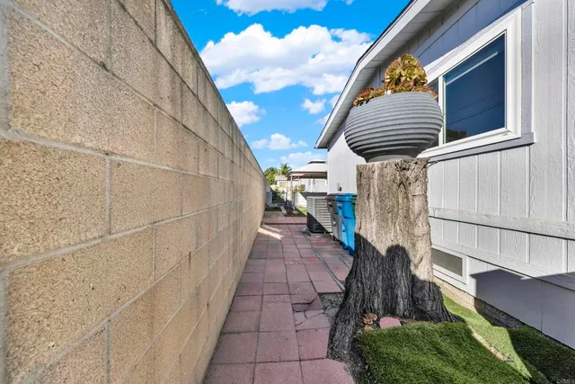 a view of a chair and table with umbrella in the patio