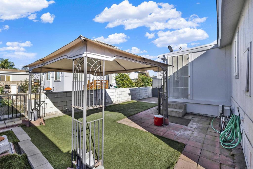 9255 North Magnolia Avenue, Unit SPC 158 Santee, CA 92071 - Photo 46 of 49 a view of a chair and table with umbrella in the patio