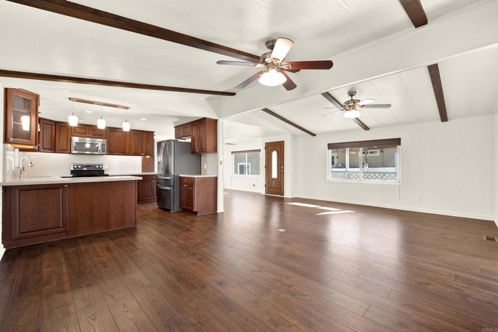 9255 North Magnolia Avenue, Unit SPC 158 Santee, CA 92071 - Photo 5 of 49 a view of a kitchen with a sink wooden floor and a kitchen