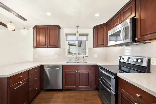 a kitchen with stainless steel appliances a sink stove and cabinets