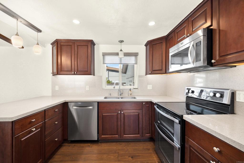 9255 North Magnolia Avenue, Unit SPC 158 Santee, CA 92071 - Photo 7 of 49 a kitchen with stainless steel appliances a sink stove and cabinets