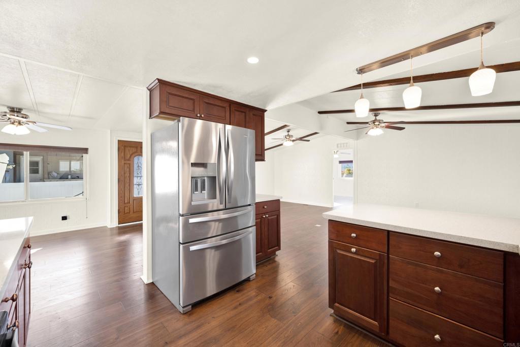 9255 North Magnolia Avenue, Unit SPC 158 Santee, CA 92071 - Photo 9 of 49 a kitchen with stainless steel appliances a refrigerator and wooden floor