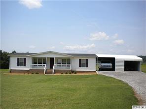 8052 Palm Tree Church Road Vale, NC 28168 - Photo 1 of 10 a front view of house with yard and outdoor seating