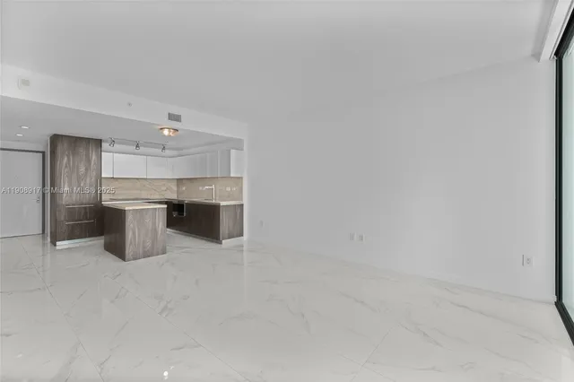 a kitchen with stainless steel appliances a stove top oven and cabinets