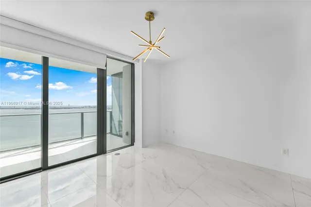 a view of a livingroom with a ceiling fan and window