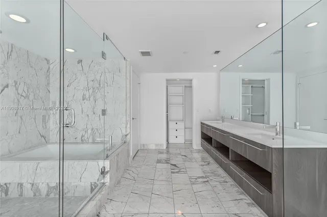 a bathroom with a double vanity sink and mirror