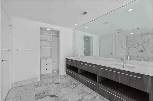 a bathroom with a double vanity sink and mirror