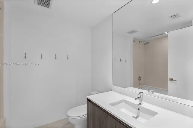 a bathroom with a sink toilet and vanity
