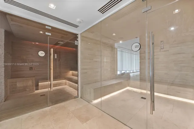 a bathroom with a glass shower door