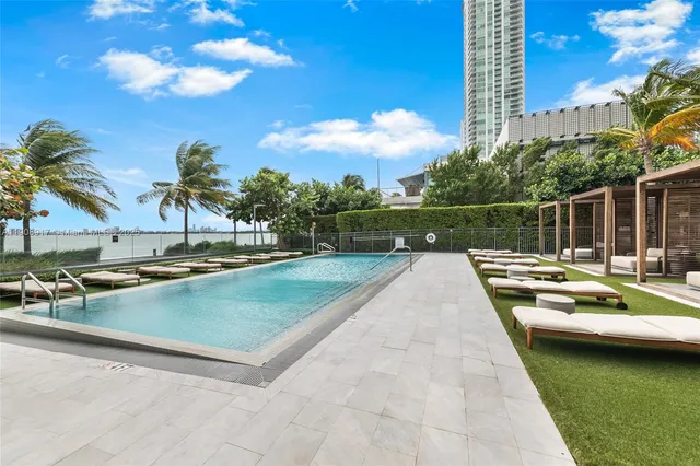 a view of swimming pool with outdoor seating and plants