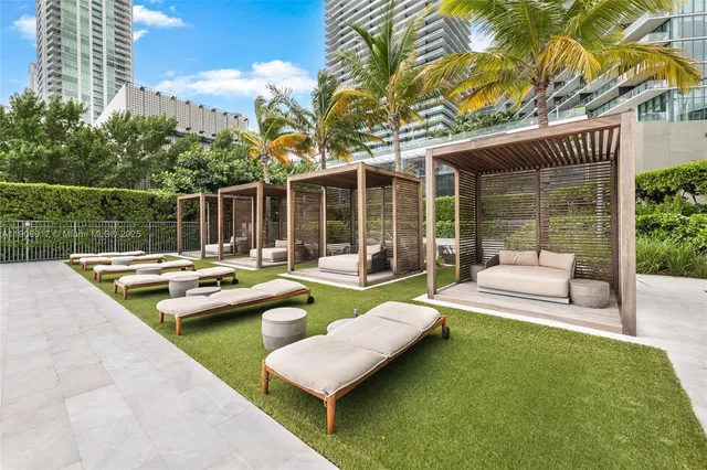 a view of swimming pool with outdoor seating and a garden
