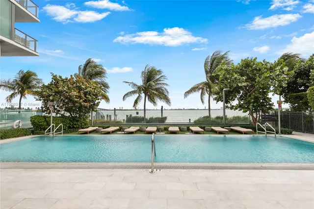 a view of swimming pool with outdoor seating and covered with lake view