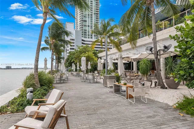 a view of a building with sitting area and garden