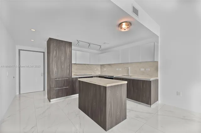 a kitchen with a sink and a refrigerator