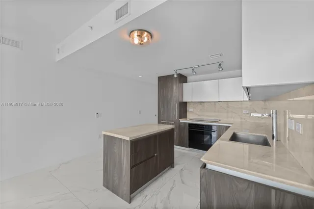 a kitchen with a cabinets and white appliances
