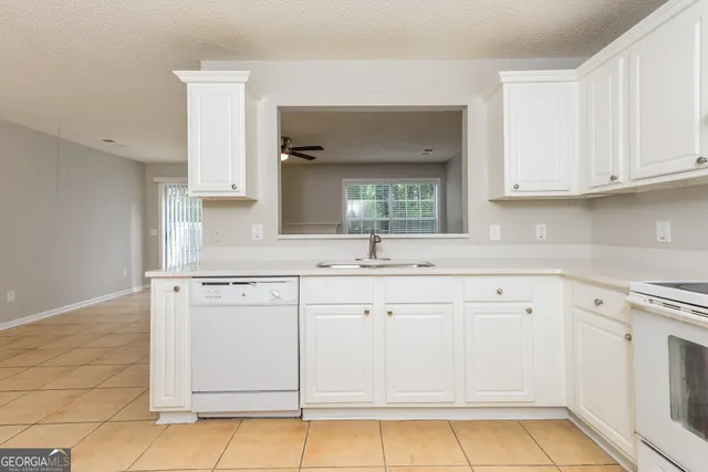 a kitchen with white cabinets