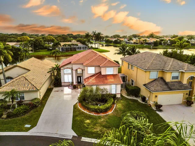 an aerial view of residential houses with outdoor space and swimming pool