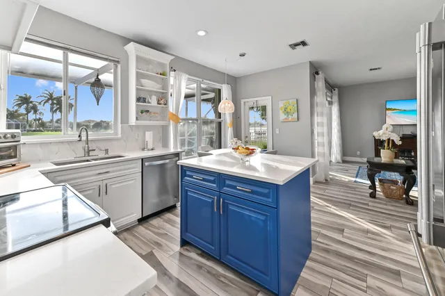 a kitchen with a sink stove top oven and cabinets