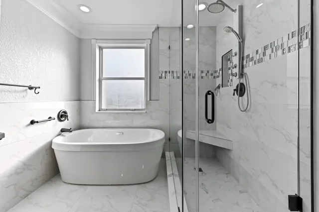 a large bed sitting in a bedroom next to a window