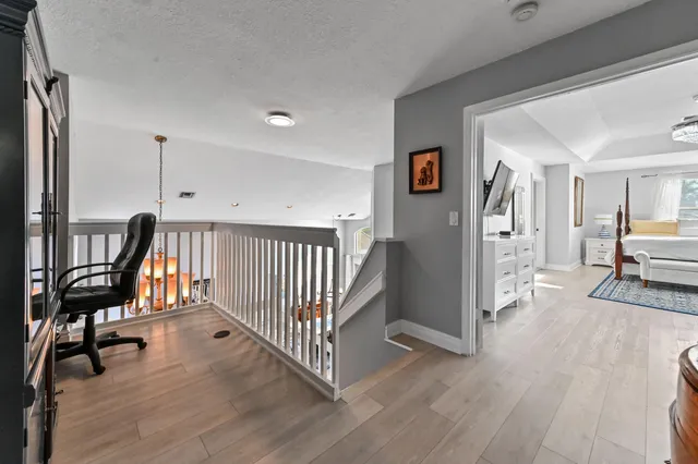 a bedroom with a large bed and a chandelier