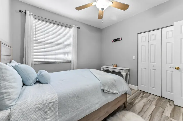 a bedroom with a bed and a chandelier