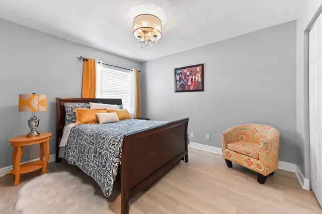 a bedroom with a bed and a chandelier