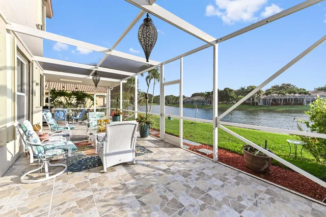 a view of a porch with furniture and garden