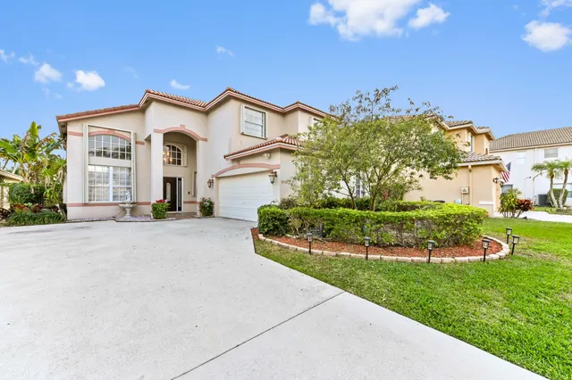 an aerial view of a house with a garden and swimming pool