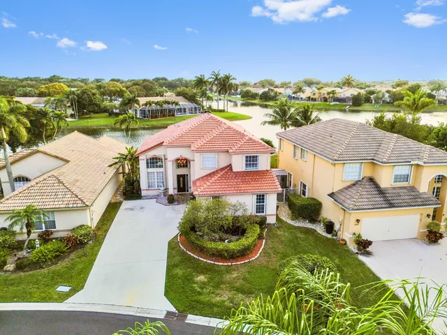 an aerial view of residential houses with outdoor space and river