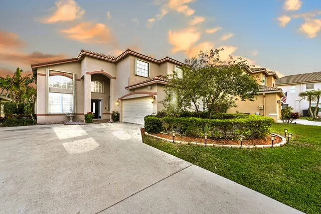 a living room with furniture a rug and a chandelier