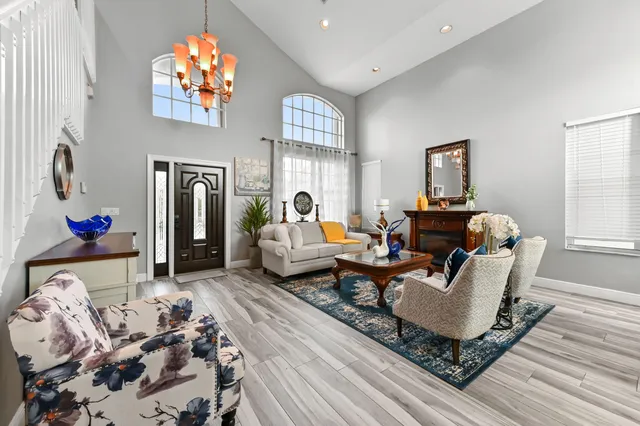 a living room with furniture a rug and a chandelier