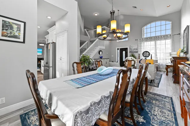 a kitchen with a stove a refrigerator and a dining table