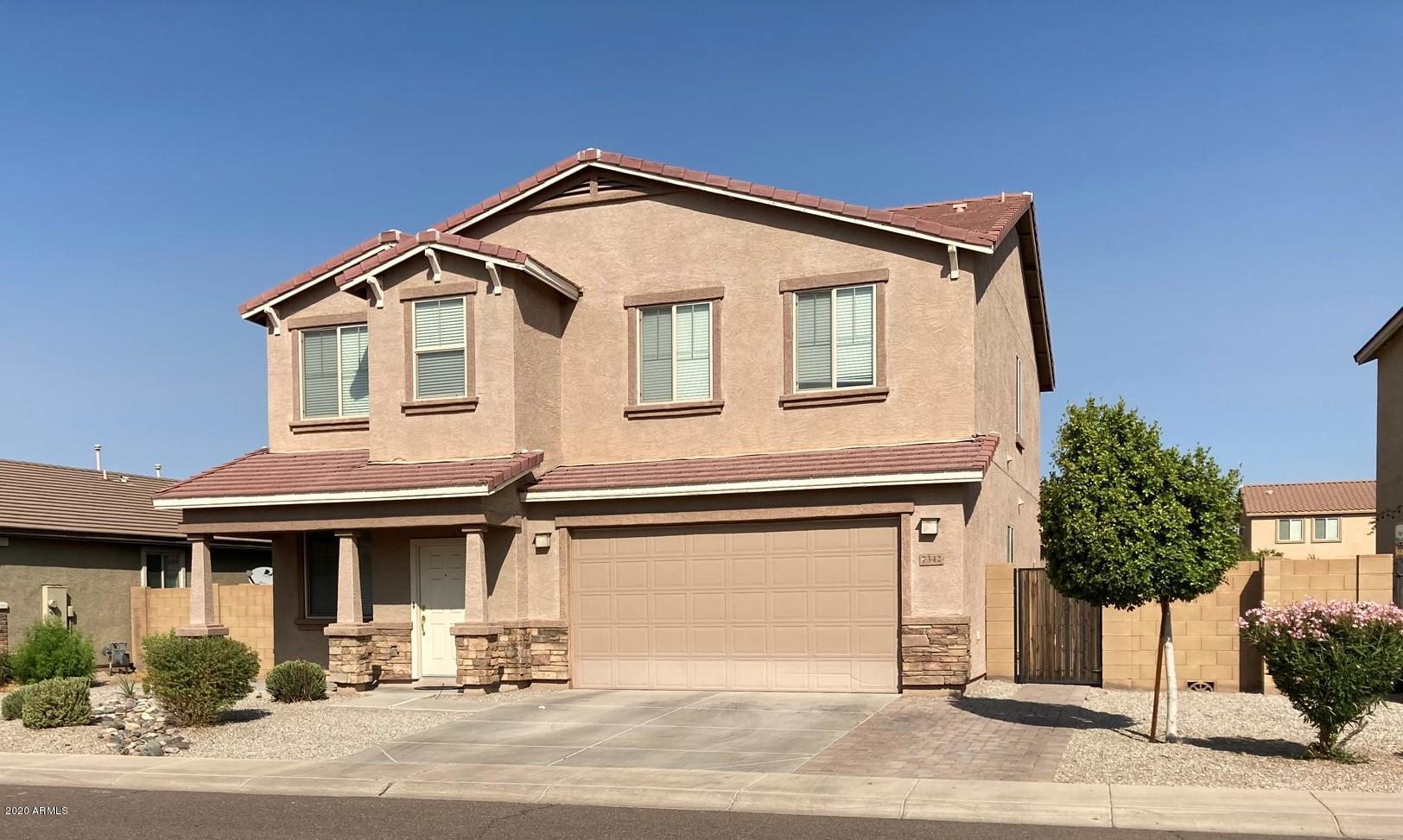 7342 West Carter Road Laveen, AZ 85339 - Photo 1 of 18 a front view of a house with a yard