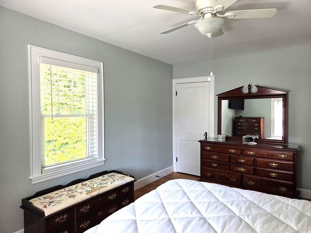 25 Waldeck Road Milton, MA 02186 - Photo 20 of 34 a bedroom with a bed and a flat tv screen on dresser