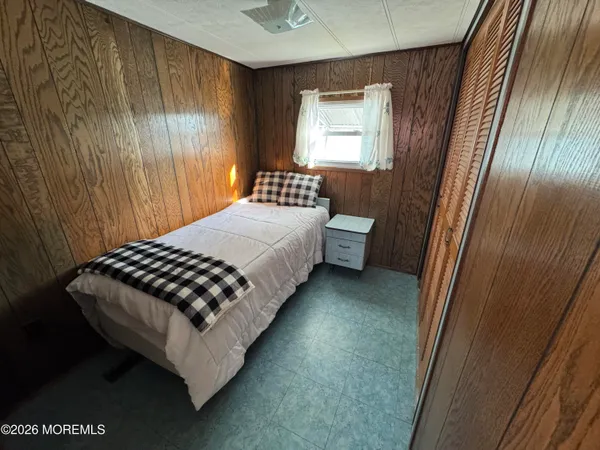 a bedroom with a bed rug and a window